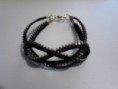 Pulsera de cremallera negra y dorada con nudo marinero